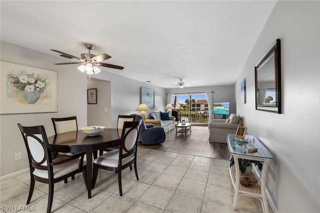 tiled dining area featuring ceiling fan