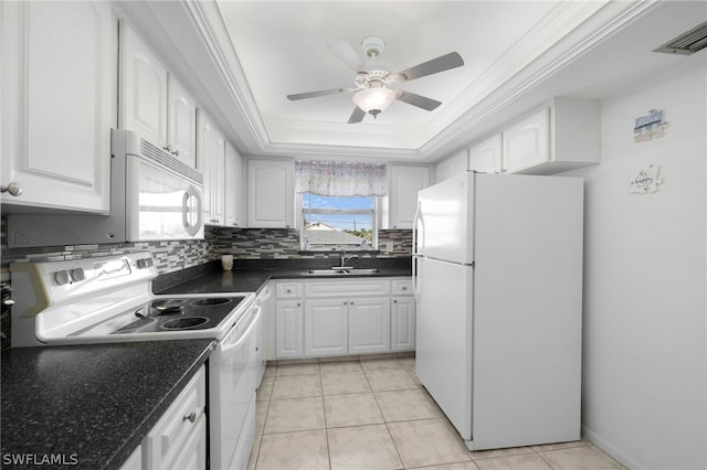 kitchen featuring visible vents, crown molding, white appliances, a raised ceiling, and a sink