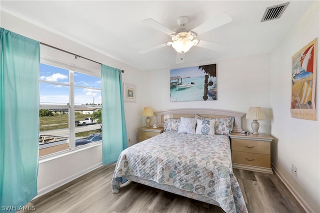 bedroom with ceiling fan and light wood-type flooring