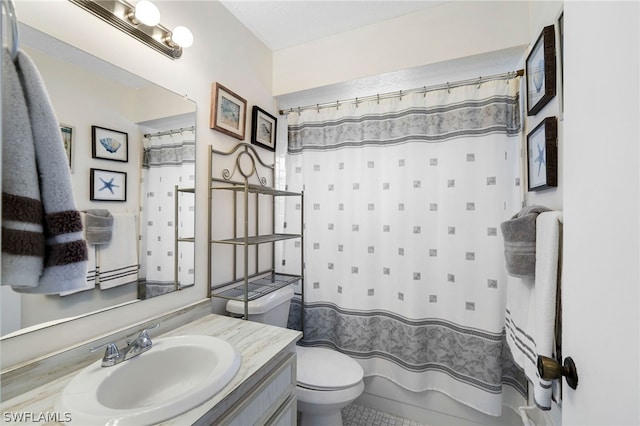 bathroom featuring toilet, vanity, and a shower with curtain