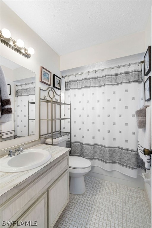 bathroom featuring vanity, shower / bath combo, tile patterned flooring, a textured ceiling, and toilet