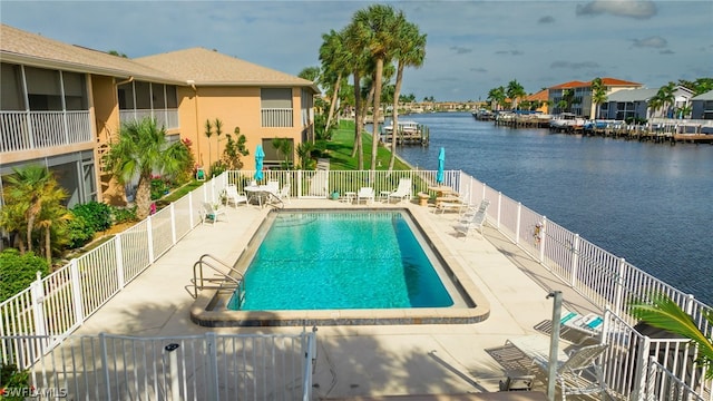 view of swimming pool with a water view and a patio area