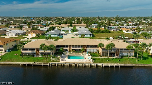 birds eye view of property with a residential view and a water view