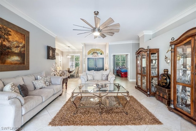 living room with ceiling fan, crown molding, and light tile patterned floors