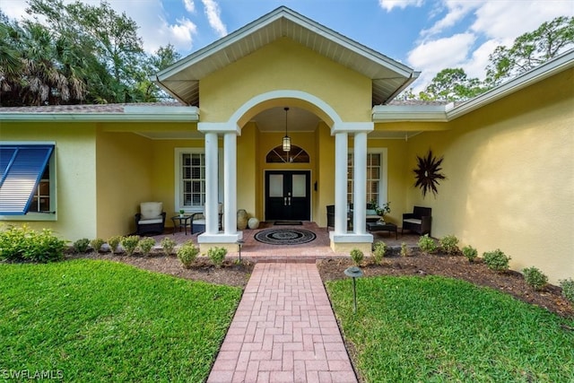 property entrance with a lawn