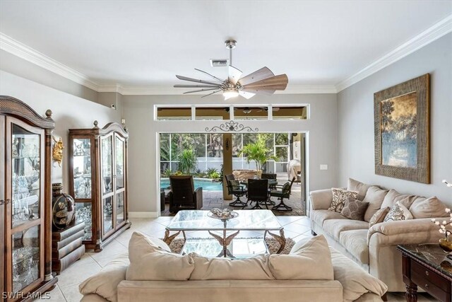 tiled living room with ceiling fan and crown molding