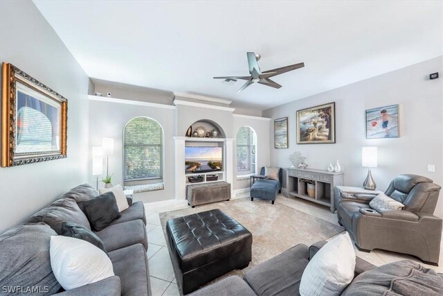 tiled living room featuring ceiling fan