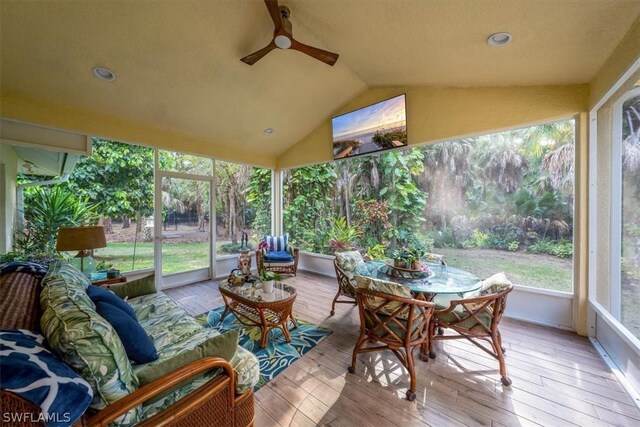 sunroom featuring lofted ceiling, ceiling fan, and a healthy amount of sunlight