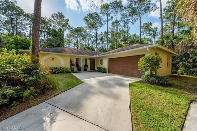 ranch-style home with a garage and a front yard