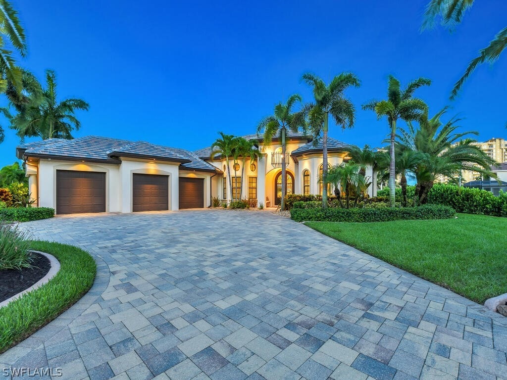 view of front facade with a garage and a front lawn