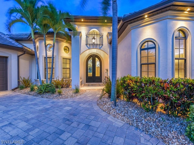 entrance to property with french doors and a balcony