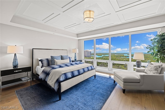 bedroom featuring coffered ceiling and hardwood / wood-style flooring