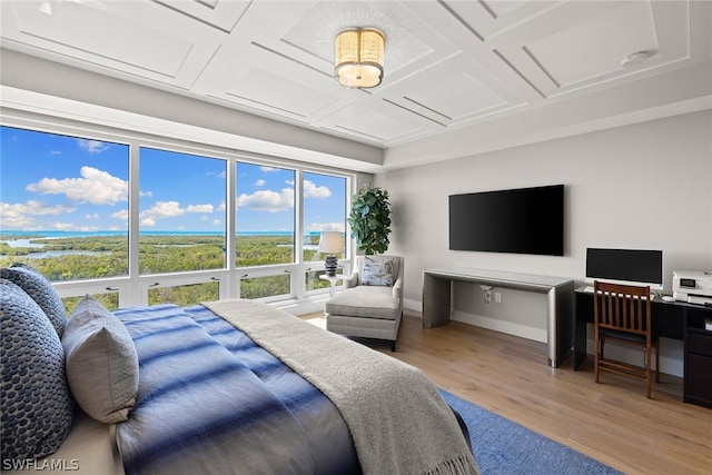 bedroom with coffered ceiling and light hardwood / wood-style flooring