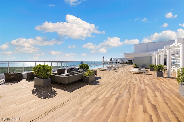 wooden terrace with a pergola and an outdoor hangout area