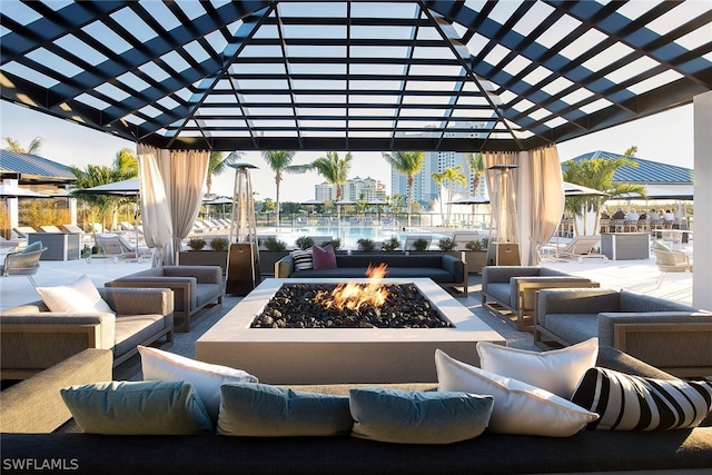 view of patio featuring an outdoor living space with a fire pit