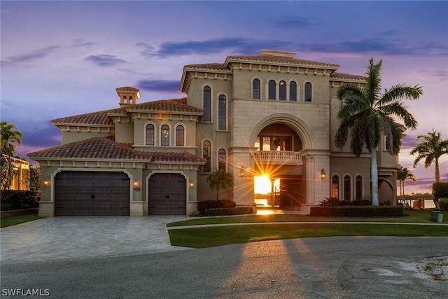 mediterranean / spanish house with a garage and a balcony