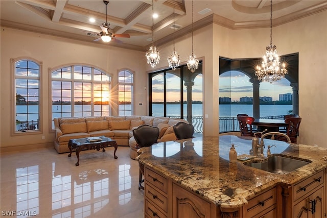 kitchen with decorative light fixtures, light tile flooring, a high ceiling, coffered ceiling, and sink