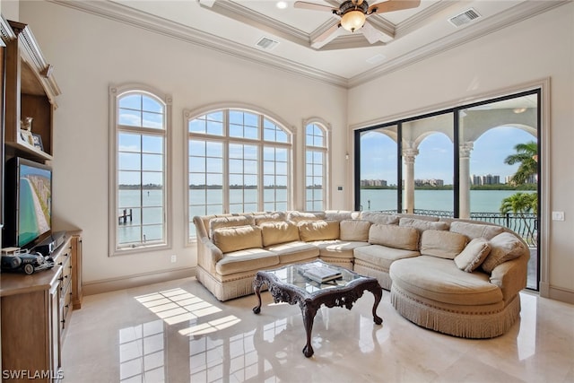 living room featuring a water view, a wealth of natural light, ceiling fan, and ornamental molding