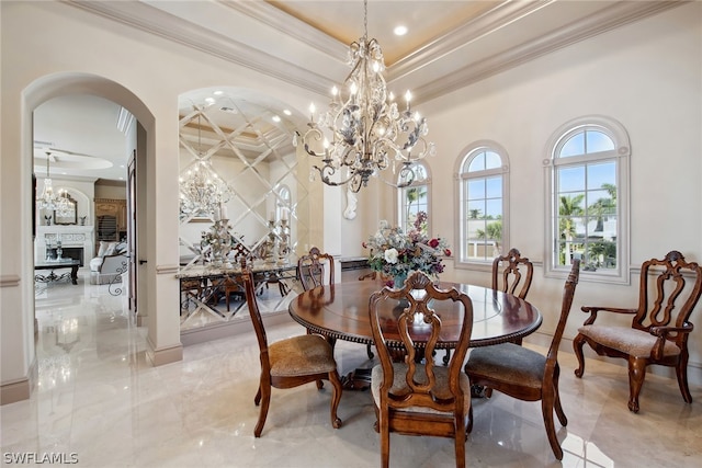 tiled dining room with a notable chandelier, crown molding, and a tray ceiling