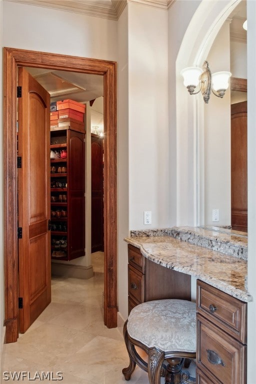 bathroom featuring ornamental molding, vanity, and tile flooring