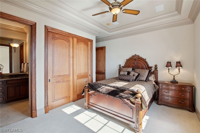 bedroom featuring light colored carpet, a raised ceiling, ceiling fan, and ornamental molding