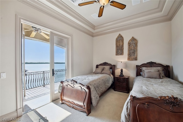 bedroom with ceiling fan, a water view, a raised ceiling, access to exterior, and light colored carpet