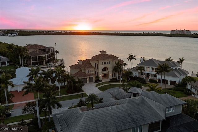 aerial view at dusk with a water view