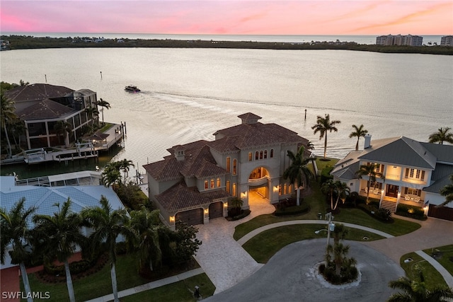 aerial view at dusk with a water view