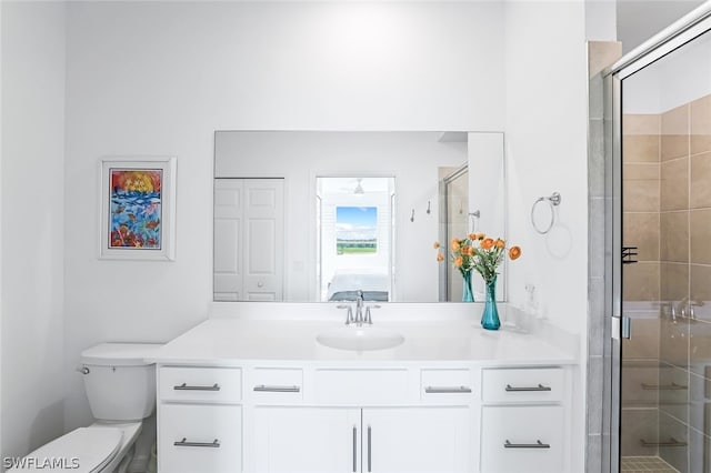 bathroom featuring a stall shower, vanity, and toilet