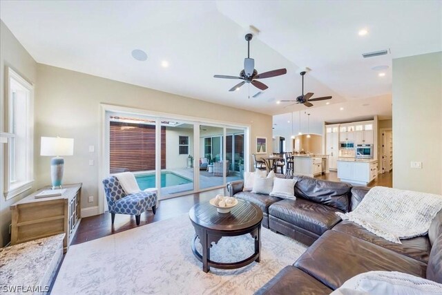 living room with ceiling fan and hardwood / wood-style floors