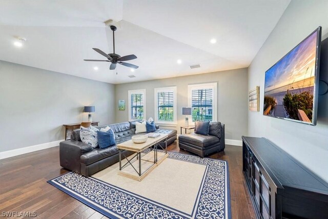 living room with ceiling fan, dark hardwood / wood-style flooring, and lofted ceiling