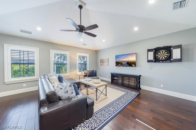 living room with vaulted ceiling, ceiling fan, and dark wood-type flooring