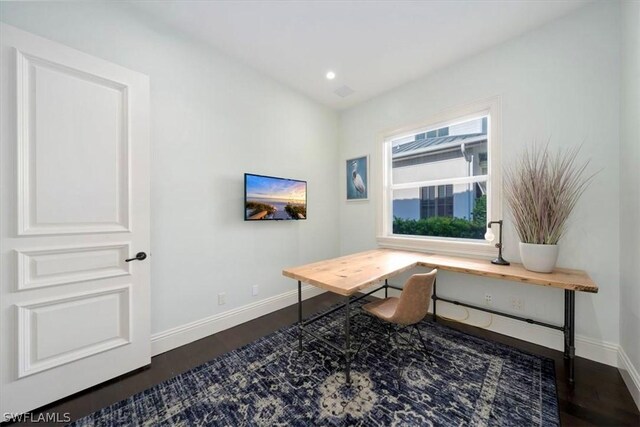 home office with dark hardwood / wood-style flooring