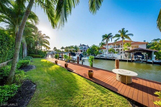 dock area featuring a water view and a lawn