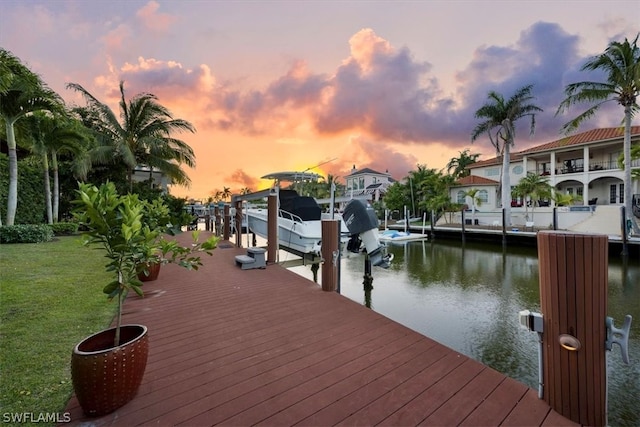 view of dock featuring a water view and a lawn