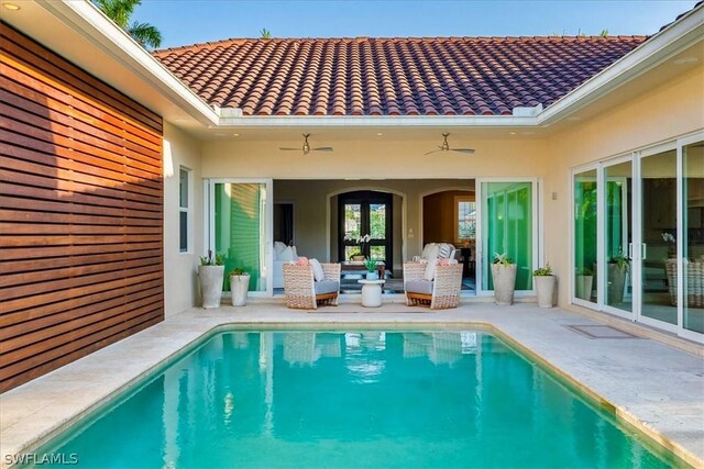 view of pool featuring an outdoor living space, ceiling fan, and a patio area