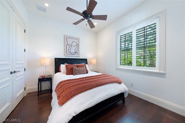 bedroom with ceiling fan, dark hardwood / wood-style flooring, and a closet