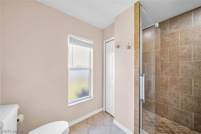 bathroom with toilet, an enclosed shower, and tile patterned floors