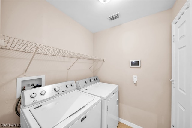 laundry area with washing machine and dryer