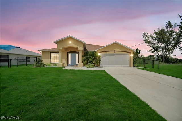 view of front facade with a lawn and a garage