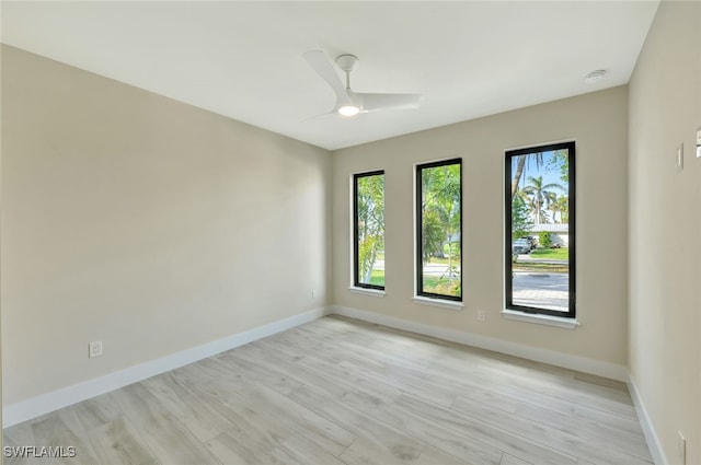 unfurnished room with ceiling fan and light wood-type flooring