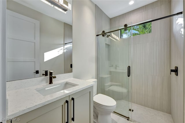 bathroom with vanity, toilet, and an enclosed shower