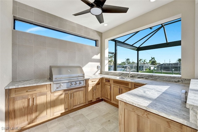 view of patio / terrace with area for grilling, ceiling fan, exterior kitchen, sink, and glass enclosure