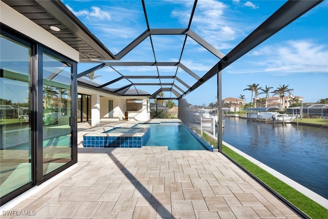 view of swimming pool featuring a lanai, a boat dock, a patio area, an in ground hot tub, and a water view