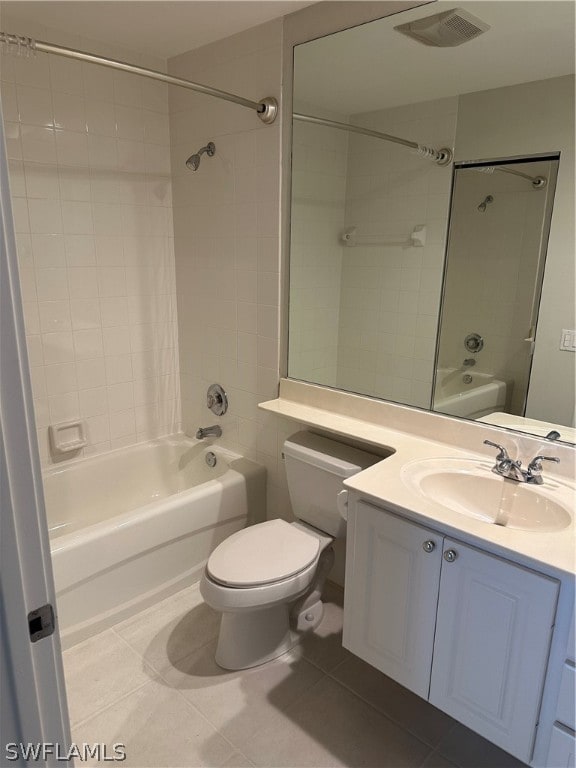 full bathroom featuring vanity, toilet, tiled shower / bath combo, and tile patterned floors