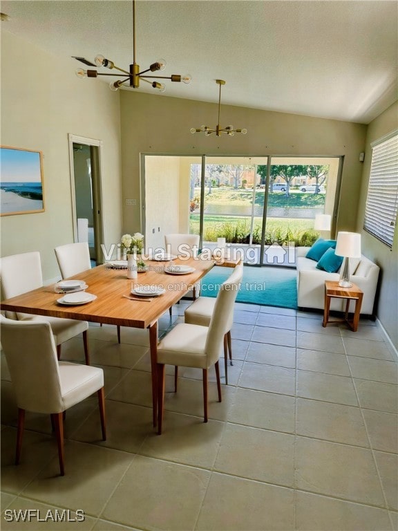 tiled dining space featuring lofted ceiling, a healthy amount of sunlight, and an inviting chandelier