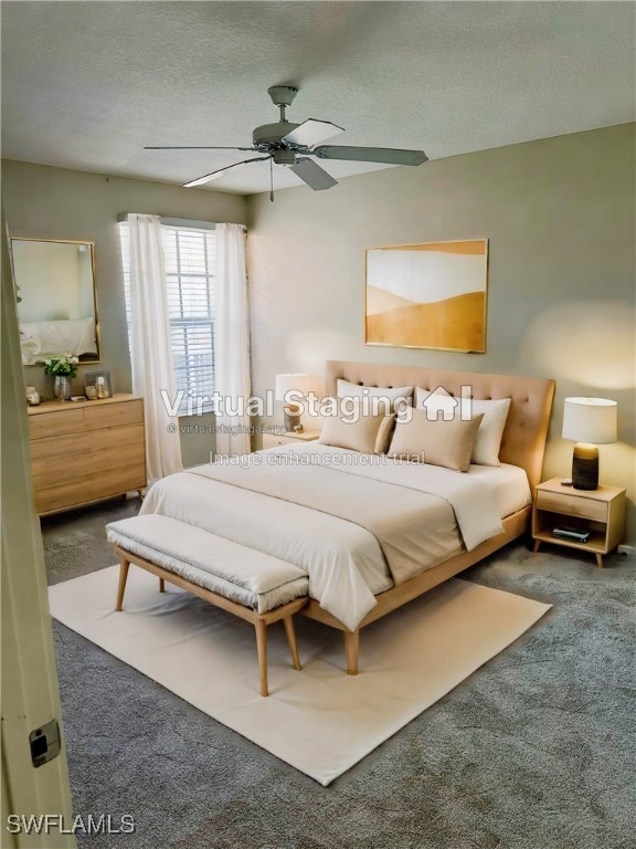 carpeted bedroom with ceiling fan and a textured ceiling