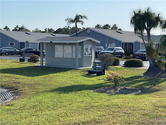 back of property with a lawn