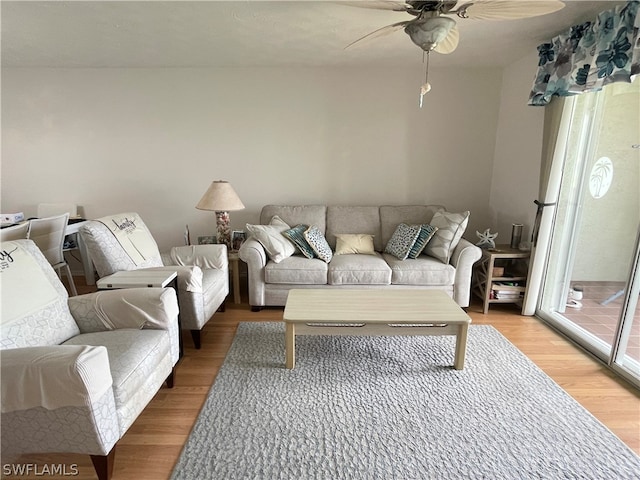 living room featuring ceiling fan and light hardwood / wood-style flooring