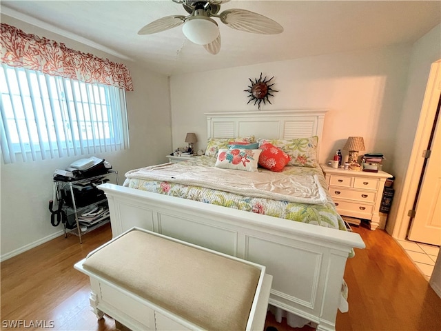 bedroom with light hardwood / wood-style flooring and ceiling fan